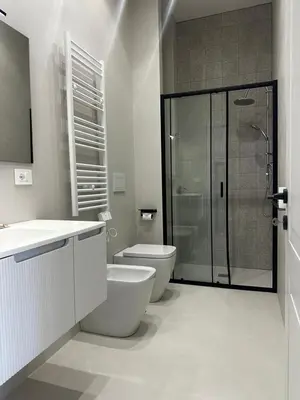 a bathroom with a toilet and a glass shower at Casa Conce two metro stops from the colosseum in Rome