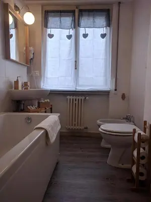 a bathroom with a tub and a sink and a toilet at Casa Vacanze Kokoroma Cipro al Vaticano in Rome