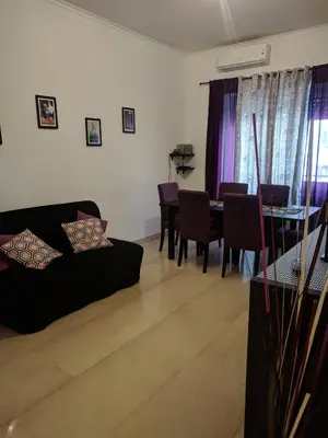 a living room with a couch and a table at Casa Vacanze Kokoroma Cipro al Vaticano in Rome