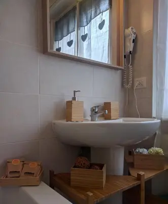 a bathroom with a sink and a mirror at Casa Vacanze Kokoroma Cipro al Vaticano in Rome