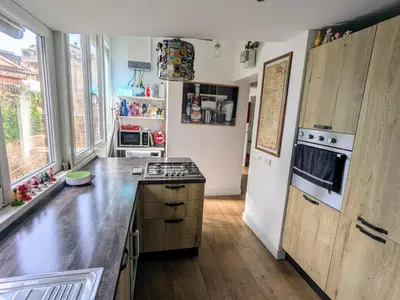 a kitchen with wooden cabinets and a counter top at Casa Fabio - Cornelia Metro A in Rome