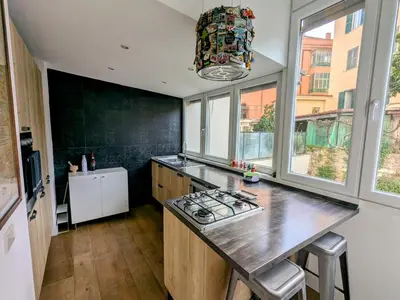 a kitchen with a counter with a stove and a window at Casa Fabio - Cornelia Metro A in Rome