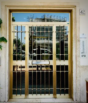 a door with a gate in front of a building at Casa Fabio - Cornelia Metro A in Rome