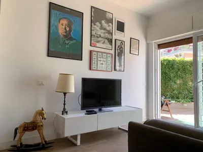 a living room with a tv and a horse statue at Casa Fabio - Cornelia Metro A in Rome
