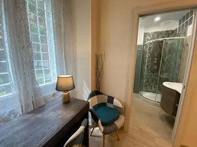 a room with a desk with a lamp and a window at Gentile RHome Apartment, casa vacanze in Rome