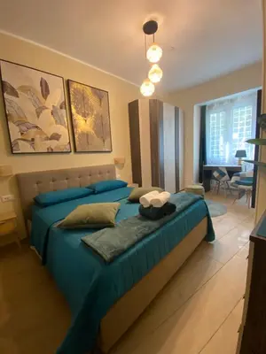 a bedroom with two beds and a living room at Gentile RHome Apartment, casa vacanze in Rome
