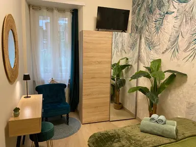 a living room with a blue chair and a television at Gentile RHome Apartment, casa vacanze in Rome