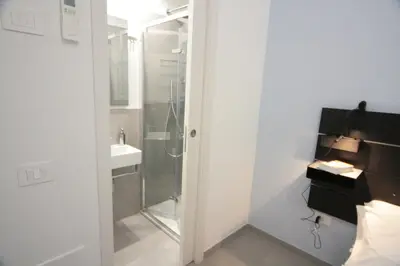 a bathroom with a shower and a sink at 1886 Colosseo Suite in Rome