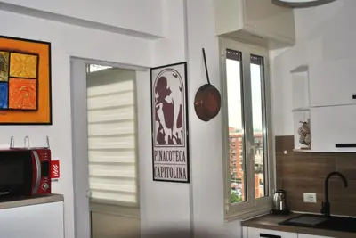 a kitchen with a window and a sign on the wall at Tiburtina Family Apartment in Rome