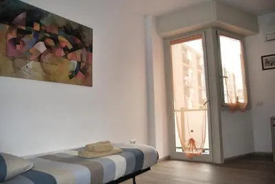 a white room with a bed and a window at Tiburtina Family Apartment in Rome