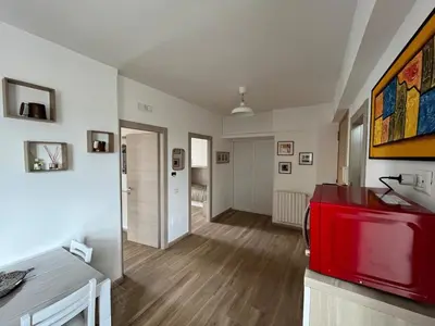 a living room with a red cabinet in a room at Tiburtina Family Apartment in Rome