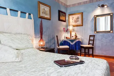 a bedroom with a bed and a table with chairs at B&B Prati in Rome