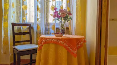 a table with a vase of flowers on it at B&B Prati in Rome