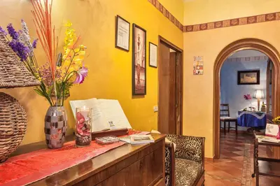 a room with a table with a vase of flowers on it at B&B Prati in Rome
