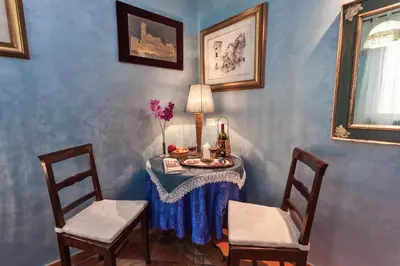a table with two chairs and a table with flowers on it at B&B Prati in Rome