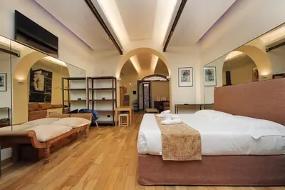 a bedroom with two beds in a room with arches at Roma Suite Loft in Rome