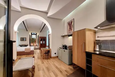 a room with a bed and a kitchen and a room with a kitchen at Roma Suite Loft in Rome