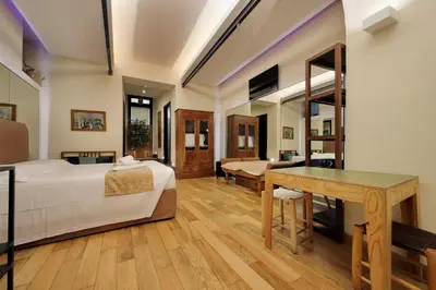 a bedroom with a bed and a desk in a room at Roma Suite Loft in Rome