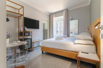 a bedroom with a large bed and a mirror at Velia Relais in Rome