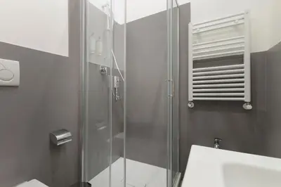 a bathroom with a glass shower and a sink at Velia Relais in Rome