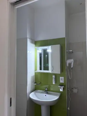 a bathroom with a sink and a mirror at Tiburtina Hotel Holiday in Rome