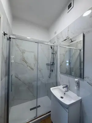 a bathroom with a shower and a sink at Tiburtina Hotel Holiday in Rome