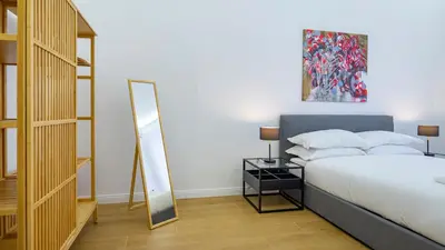 a bedroom with a bed and a mirror at Domus Re di Roma Design Suite in Rome
