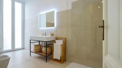 a bathroom with a sink and a mirror at Domus Re di Roma Design Suite in Rome