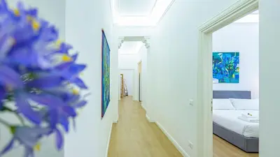 a hallway leading to a bedroom with a bed at Domus Re di Roma Design Suite in Rome