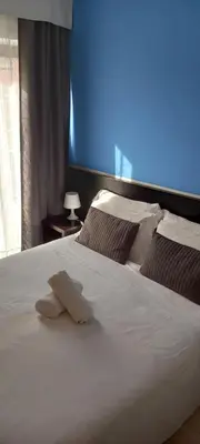 a white bed with a towel on top of it at Hotel Aniene in Rome