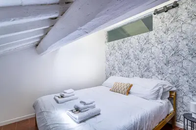 a small bedroom with a bed with towels on it at iFlat Pantheon & La Dolce Vita Skyline Penthouse in Rome