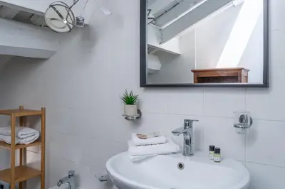 a bathroom with a sink and a mirror at iFlat Pantheon & La Dolce Vita Skyline Penthouse in Rome