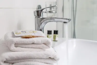 a pile of towels sitting next to a bathroom sink at iFlat Pantheon & La Dolce Vita Skyline Penthouse in Rome