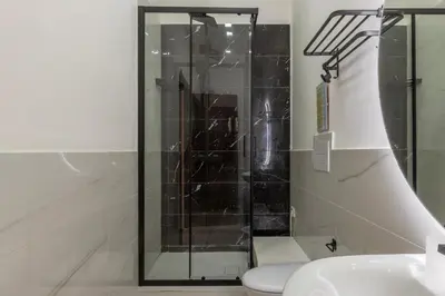 a glass shower in a bathroom with a toilet at GuestHost - Metro Cipro-Ottaviano Apartment X6 in Rome
