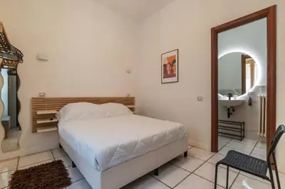 a bedroom with a bed and a mirror and a sink at GuestHost - Metro Cipro-Ottaviano Apartment X6 in Rome