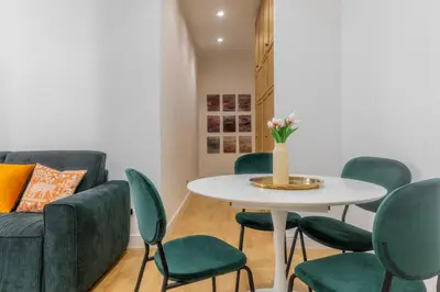 a living room with a table and green chairs at Suite23 , Roma in Rome
