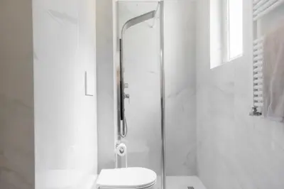a white bathroom with a shower and a toilet at Suite23 , Roma in Rome
