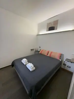 a bedroom with a bed with towels on it at Re di Roma Home in Rome