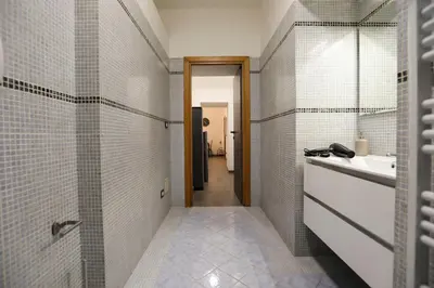 a bathroom with a sink and a mirror at Re di Roma Home in Rome