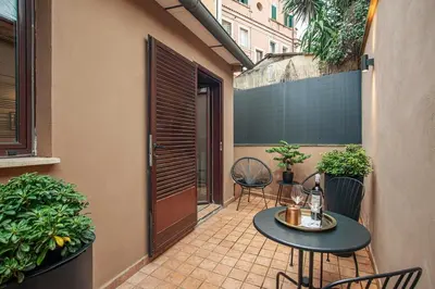 a living room and kitchen with a couch and a table at Pied-à-terre Ponte Milvio in Rome