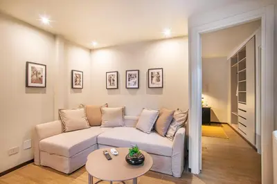 a bedroom with a large bed with a tv on the wall at Pied-à-terre Ponte Milvio in Rome