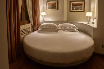 a large white bed in a room with two pillows at TreasureRome Trevi Private Palazzo in Rome