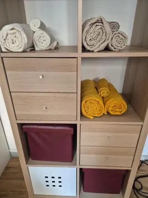 a wooden closet with towels and towels at La casetta di Laura al Gemelli-Vaticano in Rome