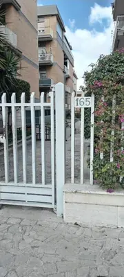 a white fence in front of a building at La casetta di Laura al Gemelli-Vaticano in Rome