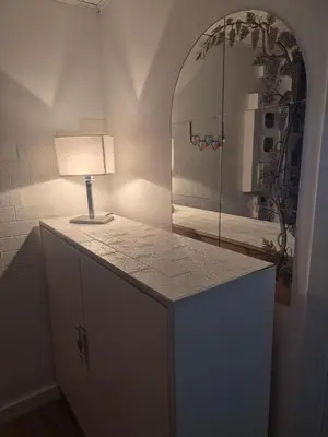 a lamp on a dresser in a room with a mirror at La casetta di Laura al Gemelli-Vaticano in Rome