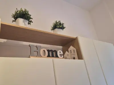 a shelf with potted plants and a home sign on it at La casetta di Laura al Gemelli-Vaticano in Rome