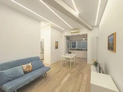 a living room with a couch and a table at Art & Garden Gemelli - Metro A - Vaticano in Rome