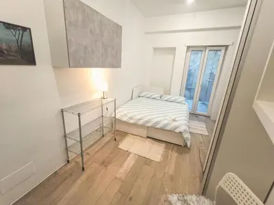 a small bedroom with a bed and a window at Art & Garden Gemelli - Metro A - Vaticano in Rome
