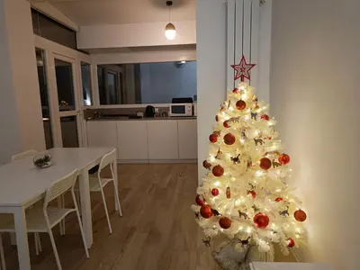 a christmas tree in a living room with a table at Art & Garden Gemelli - Metro A - Vaticano in Rome