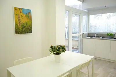 a kitchen with a white table with a potted plant on it at Art & Garden Gemelli - Metro A - Vaticano in Rome
